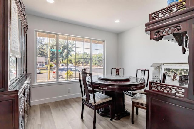 dining space with plenty of natural light and light hardwood / wood-style flooring