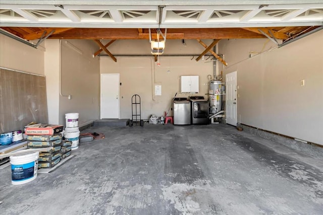 garage featuring a garage door opener, secured water heater, and independent washer and dryer