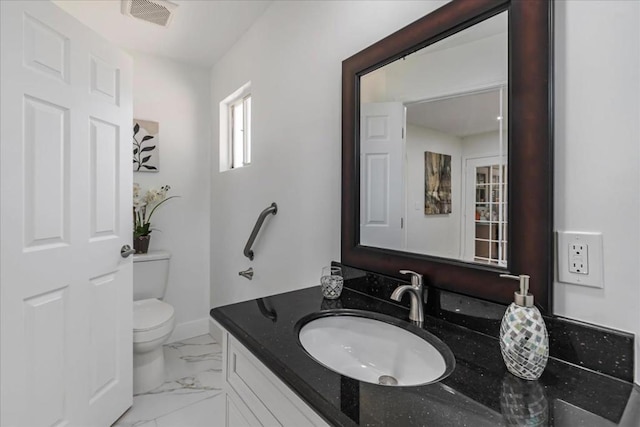 bathroom with vanity and toilet