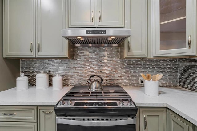 kitchen featuring stainless steel range, extractor fan, and tasteful backsplash