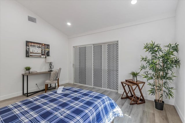 bedroom featuring wood-type flooring and lofted ceiling