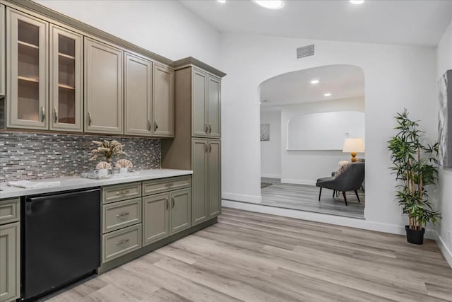 bar with light hardwood / wood-style floors, dishwasher, lofted ceiling, and tasteful backsplash