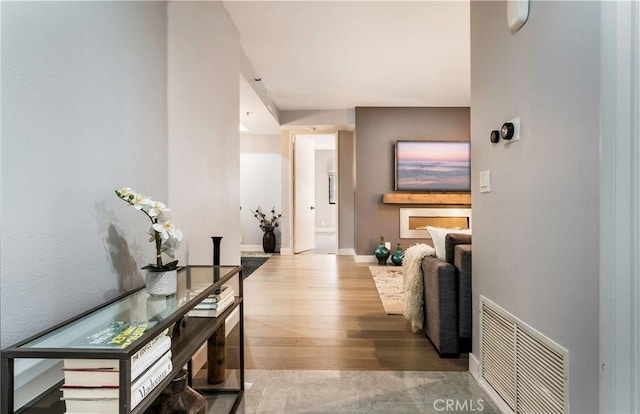 corridor with hardwood / wood-style floors