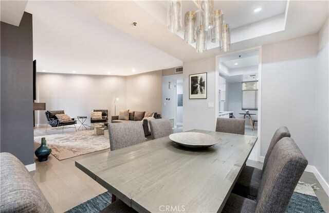 dining space featuring a notable chandelier and hardwood / wood-style floors