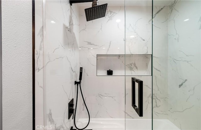 details featuring a marble finish shower