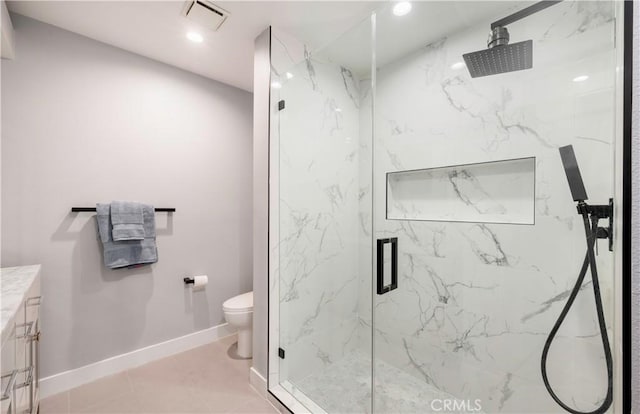 bathroom featuring a marble finish shower, visible vents, toilet, vanity, and baseboards