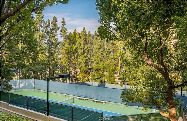 view of tennis court with fence