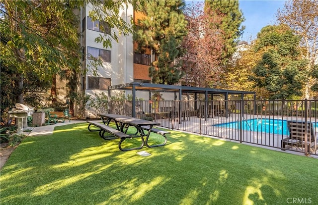 surrounding community featuring a swimming pool, a lawn, a patio area, and fence