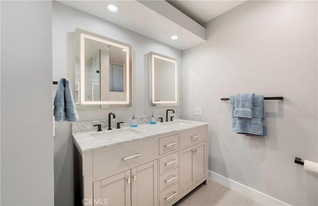 bathroom featuring recessed lighting, a sink, baseboards, and double vanity