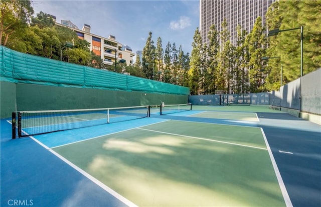 view of tennis court with fence