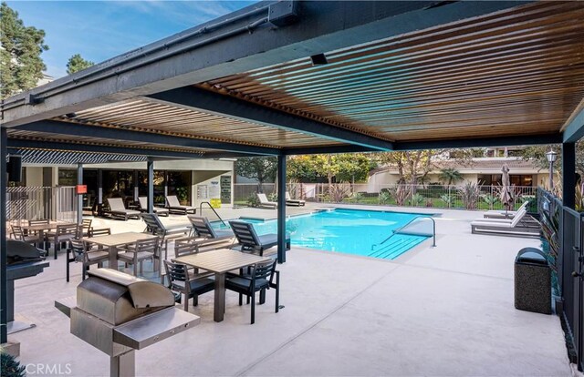 view of pool featuring grilling area and a patio