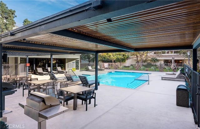 community pool featuring fence, grilling area, a pergola, and a patio