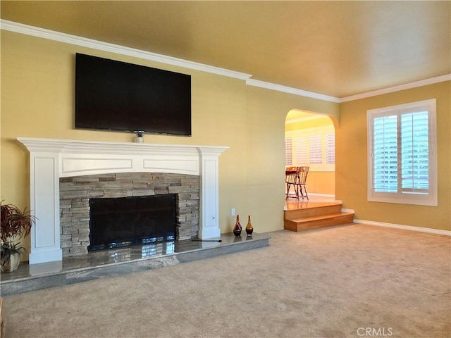 carpeted living room with ornamental molding and a fireplace