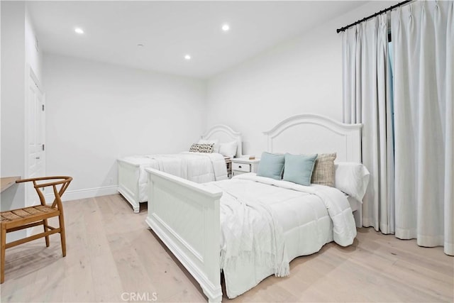 bedroom with recessed lighting, baseboards, and light wood finished floors