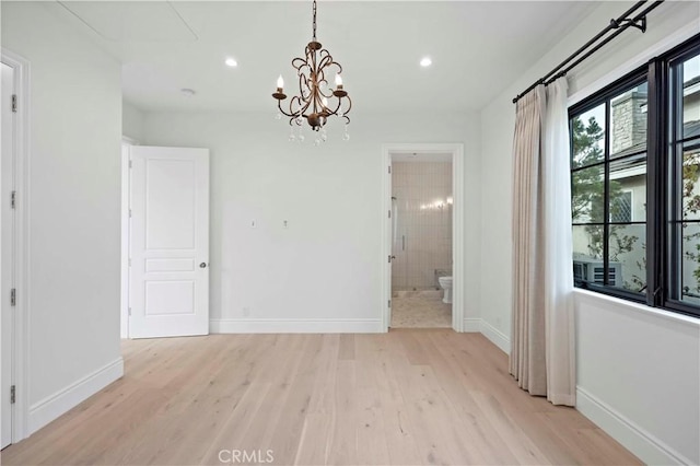 unfurnished dining area featuring recessed lighting, light wood-type flooring, baseboards, and a chandelier