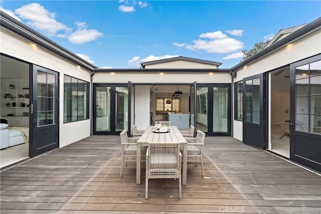 wooden deck featuring outdoor dining area