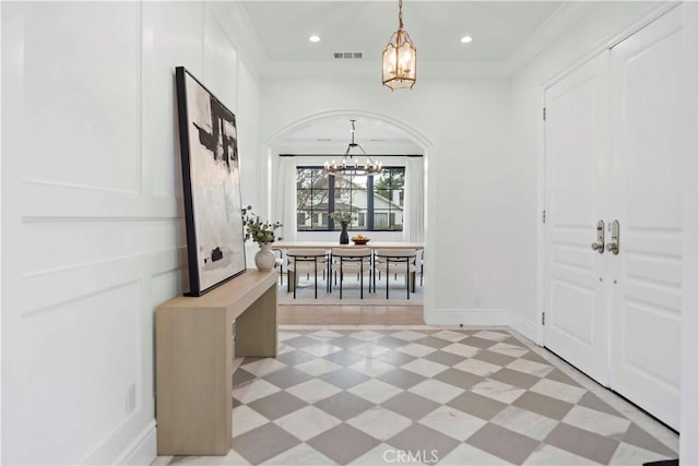 foyer entrance with visible vents, ornamental molding, recessed lighting, light floors, and a chandelier