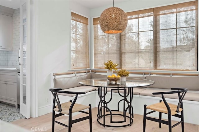 dining room with light wood finished floors and breakfast area