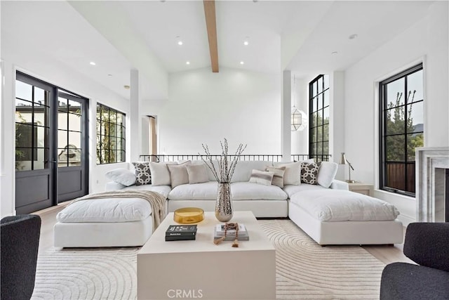 living area with recessed lighting, lofted ceiling with beams, and wood finished floors