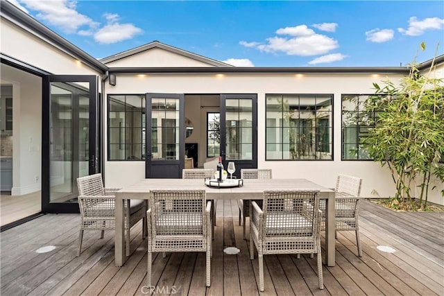 wooden terrace featuring outdoor dining space