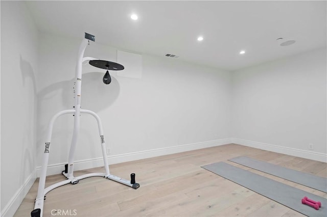 exercise room with recessed lighting, visible vents, baseboards, and wood finished floors