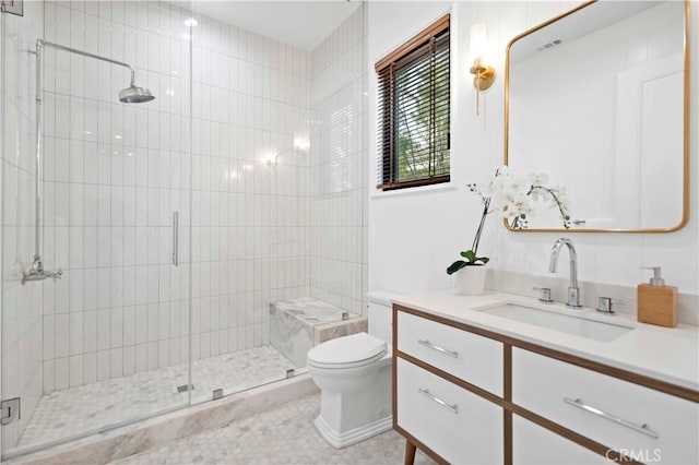 bathroom featuring a stall shower, toilet, and vanity