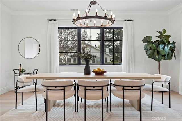 dining area featuring an inviting chandelier, plenty of natural light, and light hardwood / wood-style floors