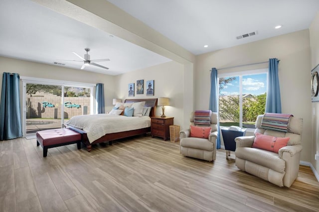 bedroom with ceiling fan, access to exterior, light hardwood / wood-style flooring, and multiple windows