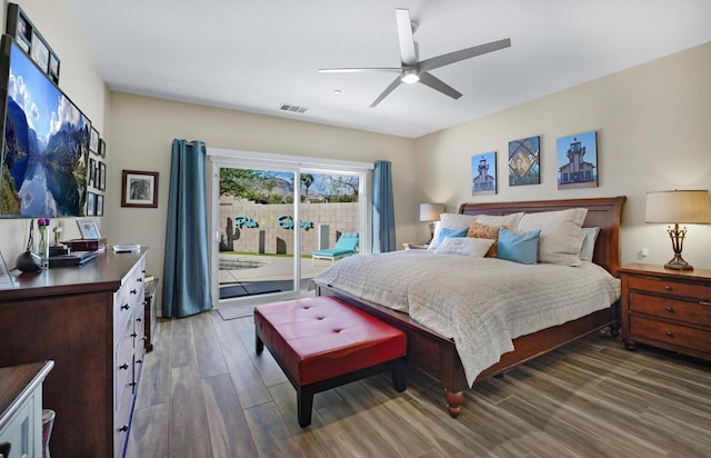 bedroom with dark wood-type flooring, ceiling fan, and access to exterior