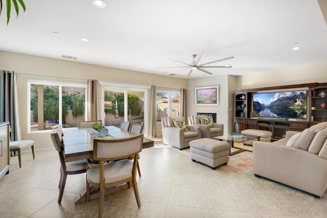 living room with ceiling fan and light tile patterned flooring