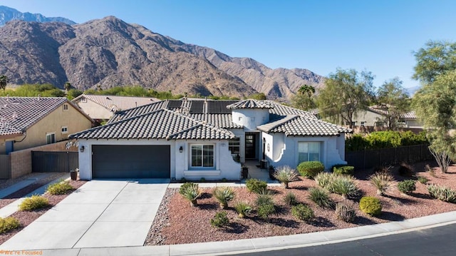 mediterranean / spanish-style house with a garage and a mountain view