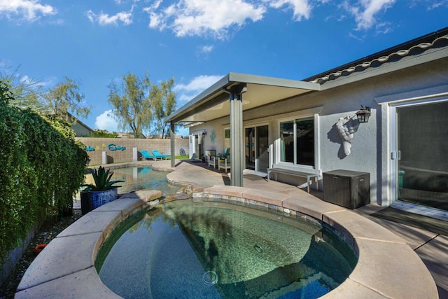 view of swimming pool with a patio and an in ground hot tub