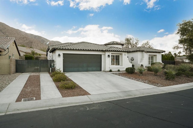 view of front of house featuring a garage and a mountain view