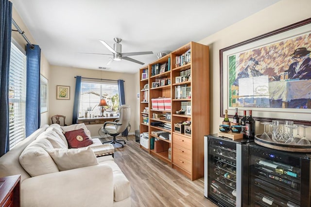 sitting room with light hardwood / wood-style floors and ceiling fan