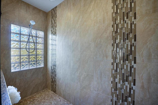 bathroom with a tile shower