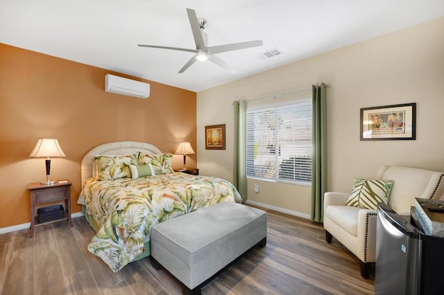 bedroom featuring ceiling fan, dark hardwood / wood-style floors, and a wall mounted air conditioner