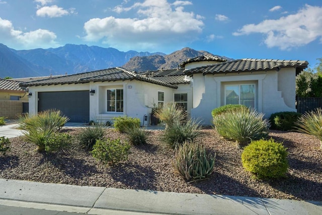 mediterranean / spanish house featuring a mountain view and a garage