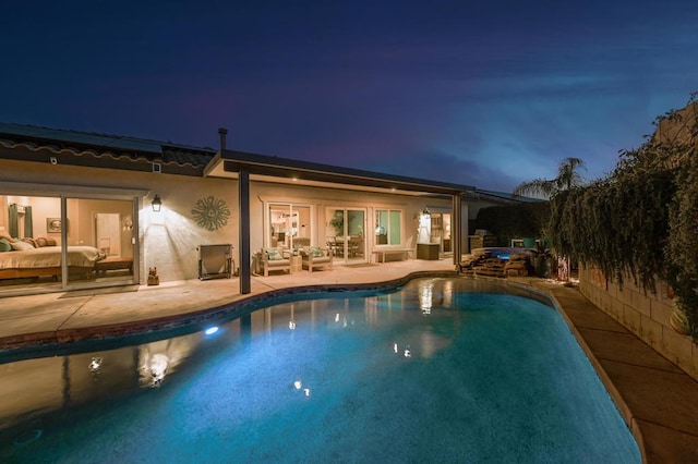 pool at night with a patio