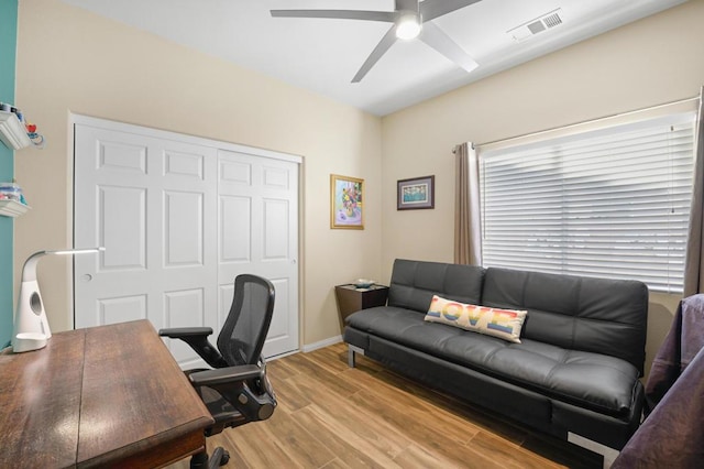 home office with ceiling fan and light wood-type flooring