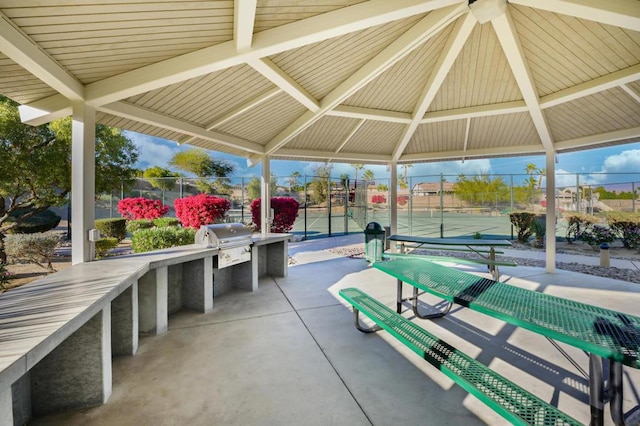 view of community featuring tennis court and a gazebo