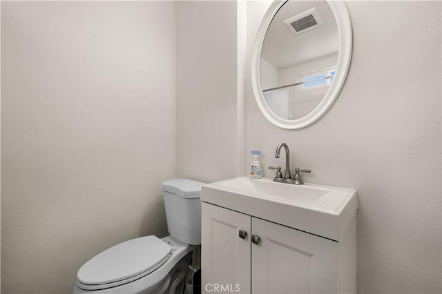 bathroom with toilet and vanity