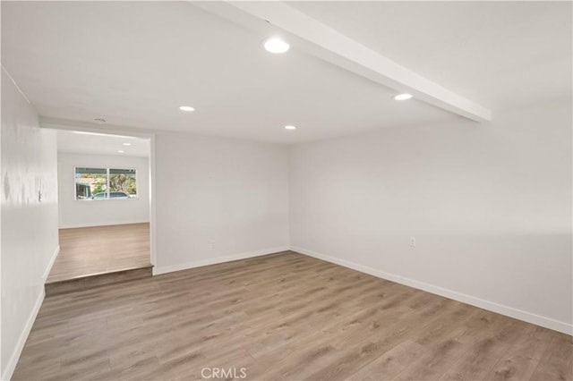 unfurnished room featuring beam ceiling and hardwood / wood-style flooring