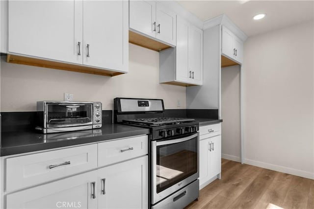 kitchen featuring white cabinetry, gas stove, and light hardwood / wood-style flooring