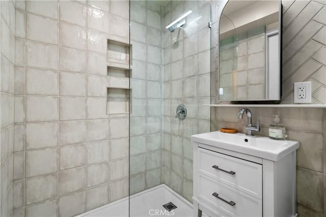 bathroom with vanity and tiled shower