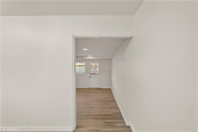 corridor featuring hardwood / wood-style floors