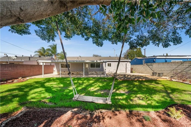 rear view of property featuring a yard