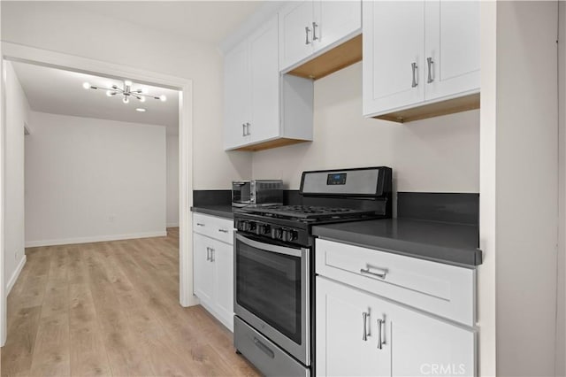 kitchen featuring white cabinetry, stainless steel gas stove, and light hardwood / wood-style flooring