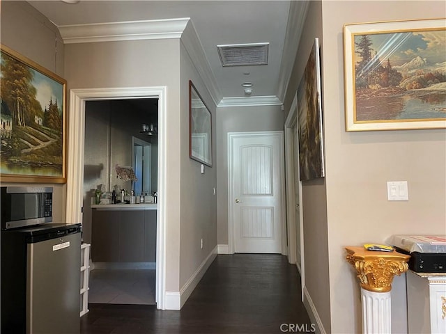 corridor featuring dark hardwood / wood-style floors and crown molding