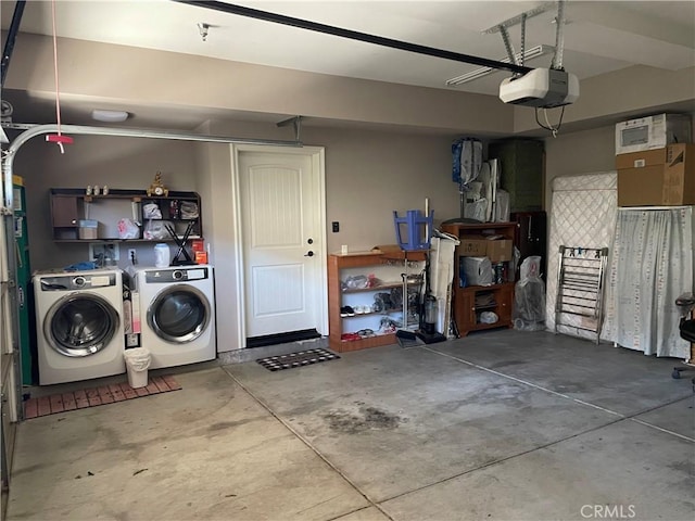 garage featuring independent washer and dryer and a garage door opener