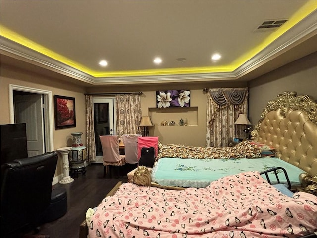 bedroom with a raised ceiling and hardwood / wood-style flooring